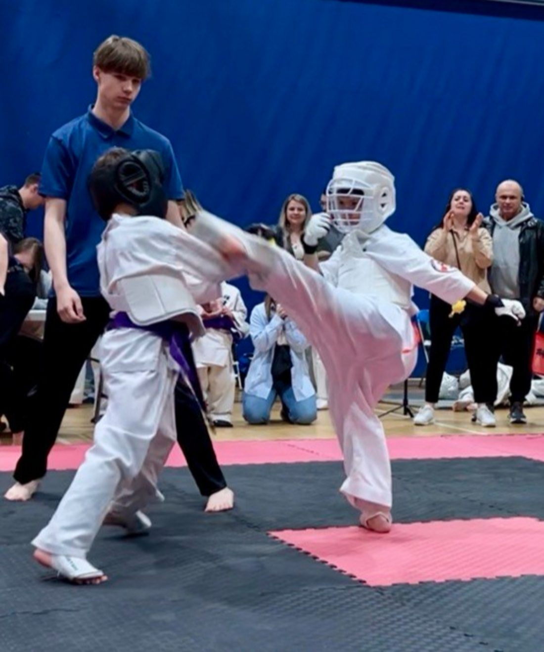 A Winterpeg Dojo student landing a high kick during a tournament fight