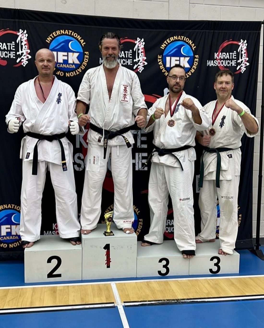 Coach Bogdan Grazhdan on the second place podium step at the IFK Canada championship