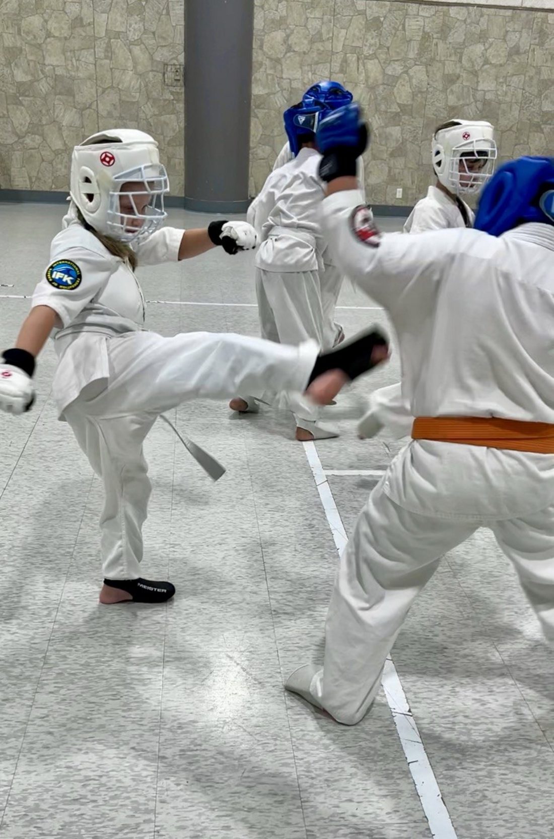 Students practicing sparring (kumite) with protective gear at Winterpeg Dojo